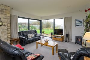 Sitting room with glass windows and sliding door to the patio and garden- click for photo gallery